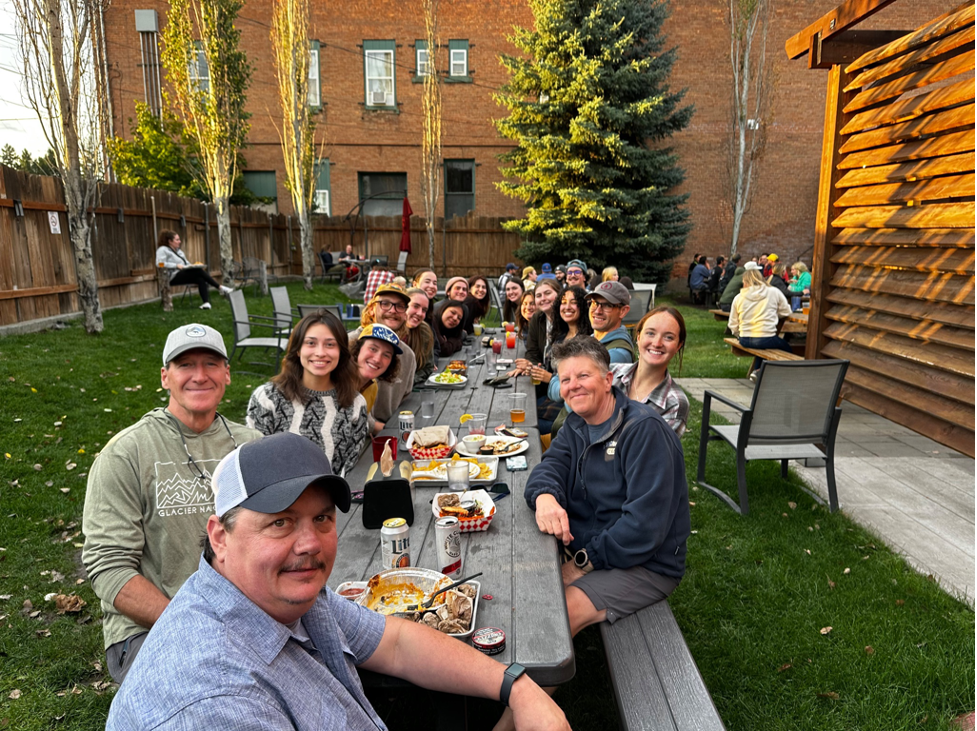 A table full of friends at a beer garden.