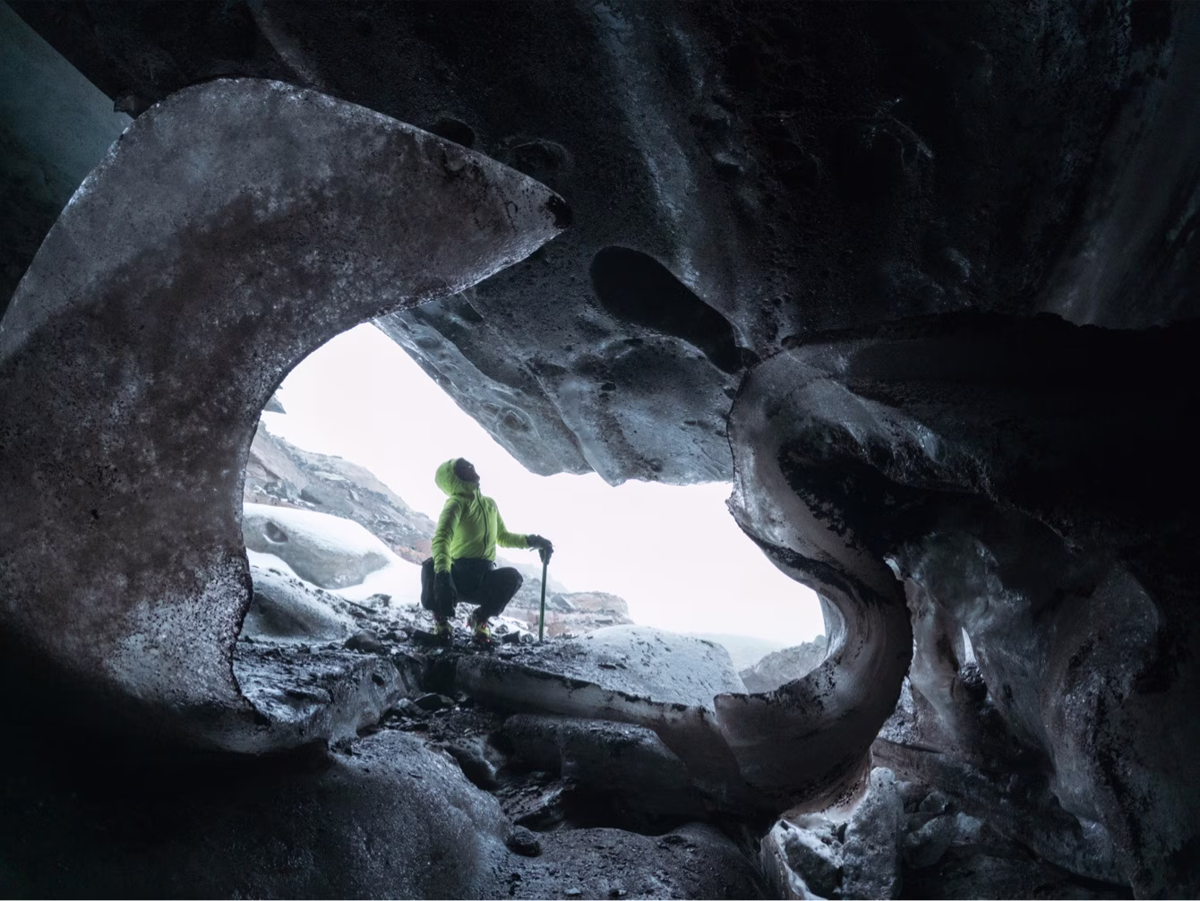 A woman examining an ice cave.