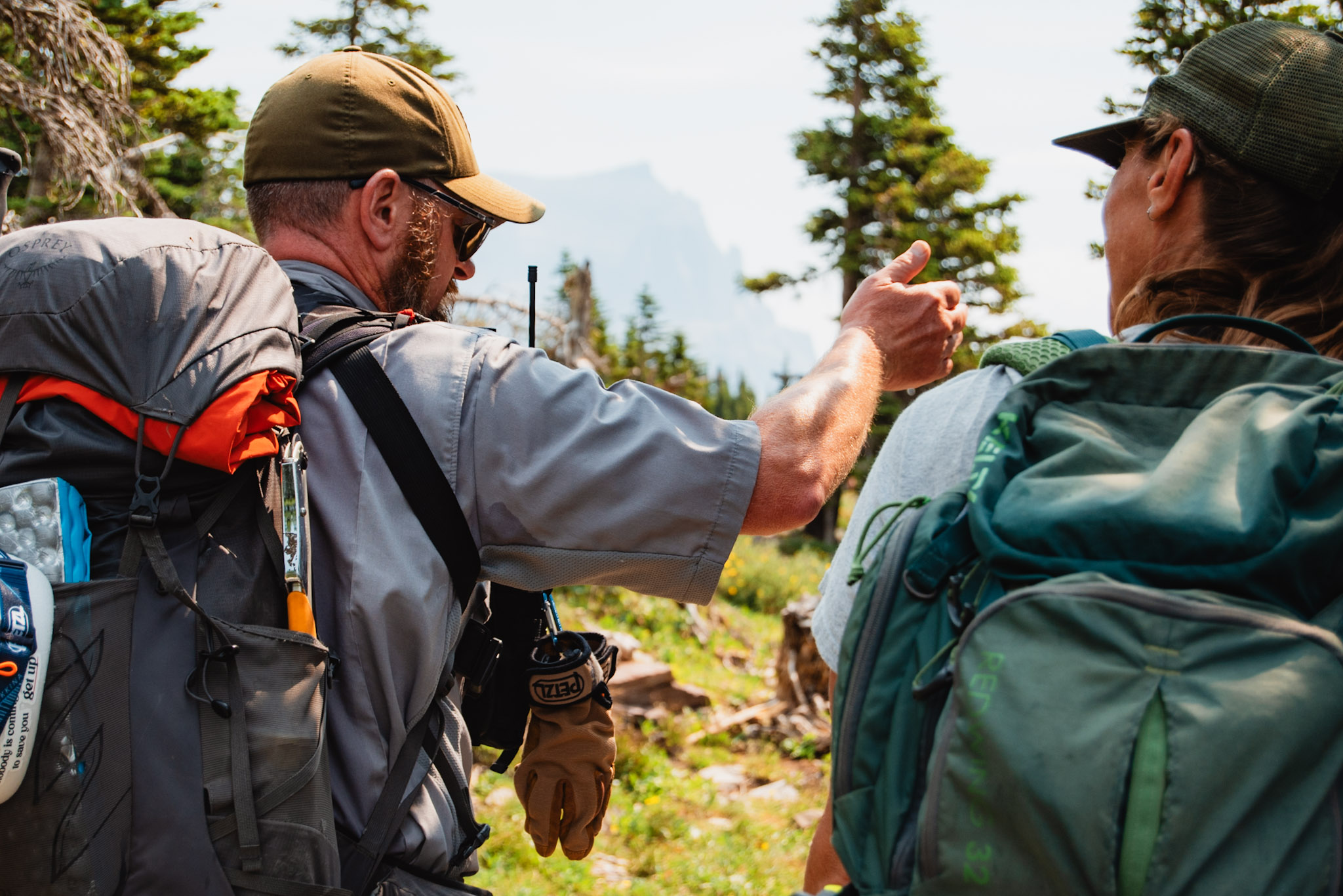 A ranger explains something to a visitor.